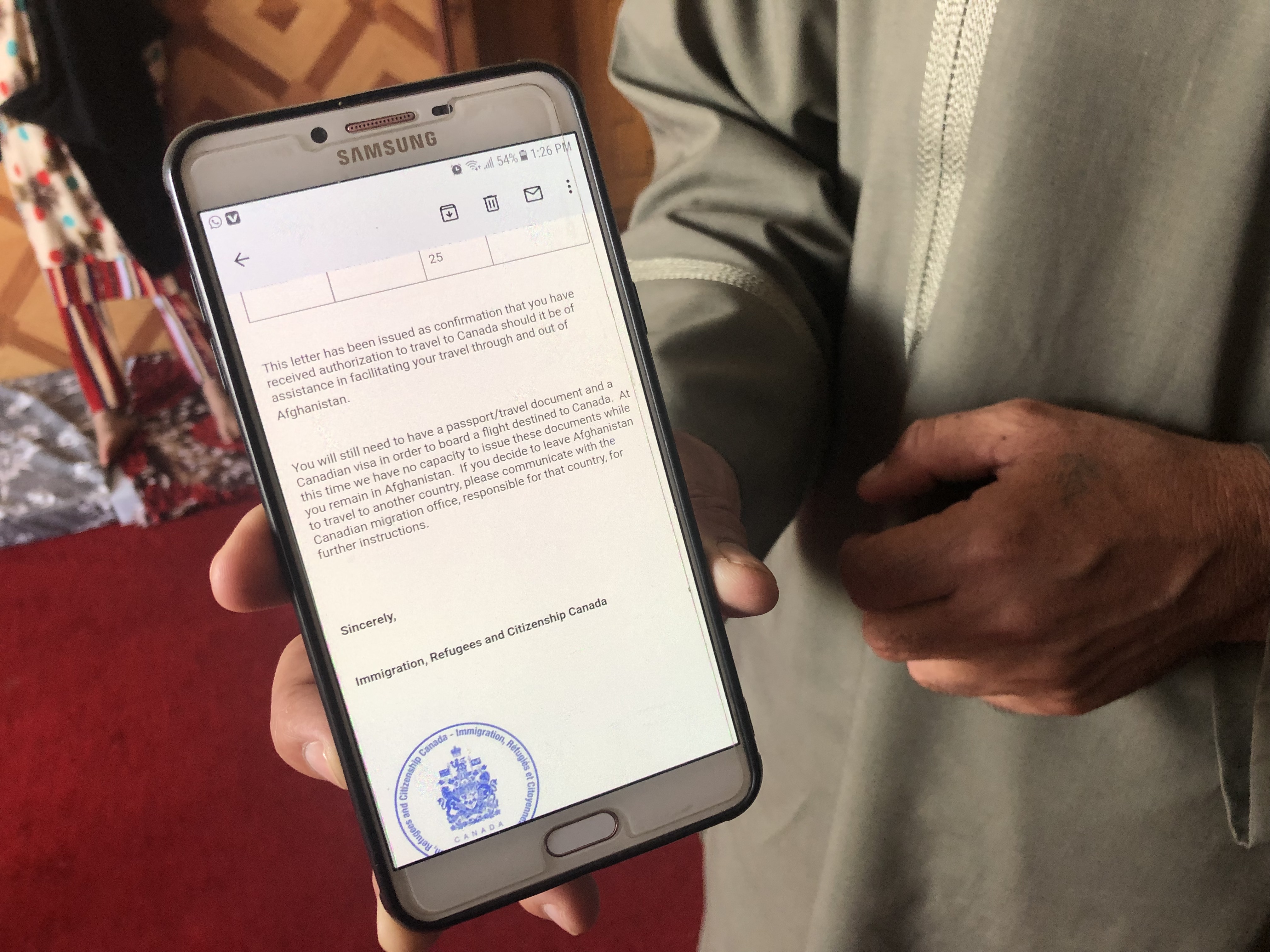Former Canadian Forces employee Driver Gafar shows an email authorizing him to travel to Canada, but he said he remained stranded at a Kabul safe house.