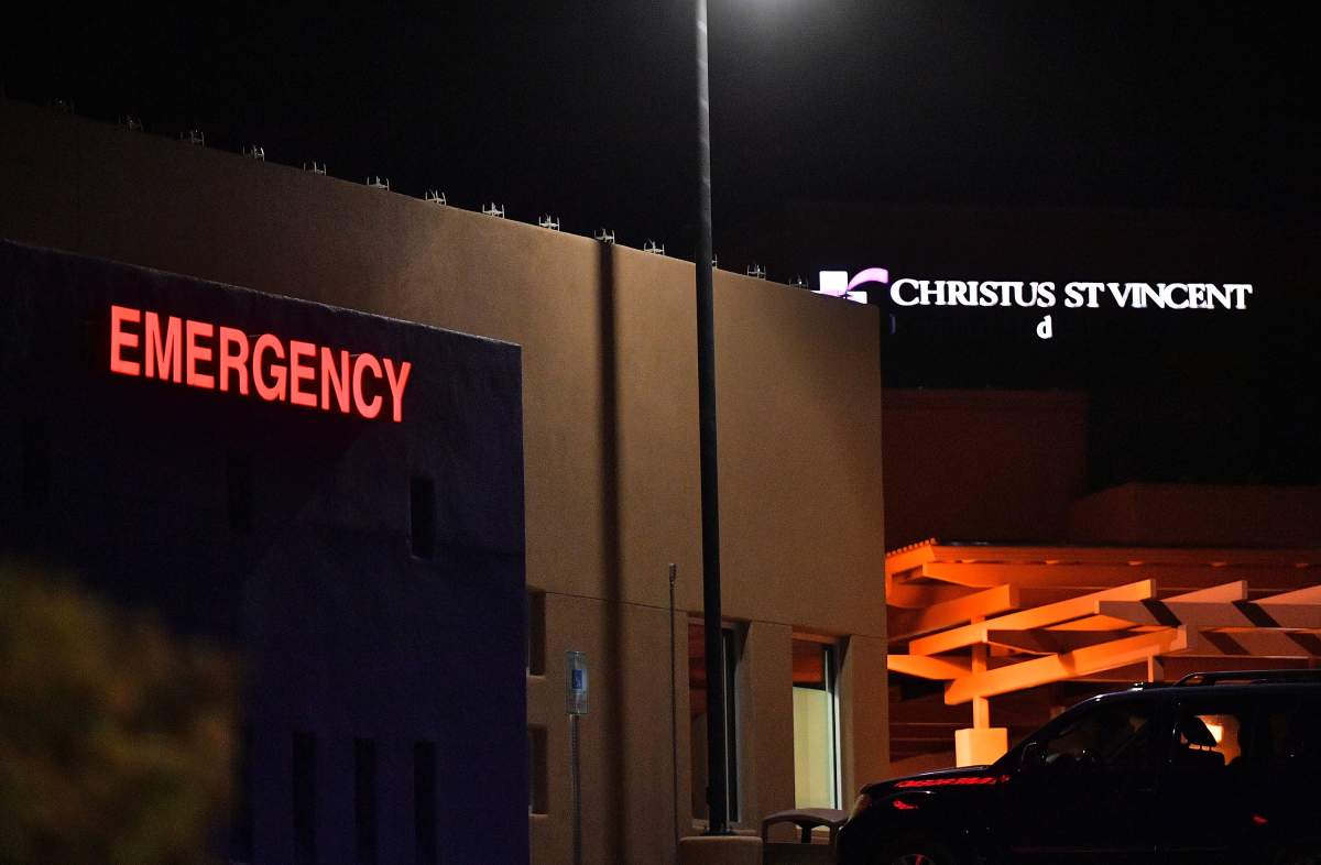 An exterior view shows a lighted ‘EMERGENCY’ sign near the emergency entrance to Christus St. Vincent Medical Center, where “Rust” director Joel Souza was transported, on Oct. 21, 2021 in Santa Fe, New Mexico.