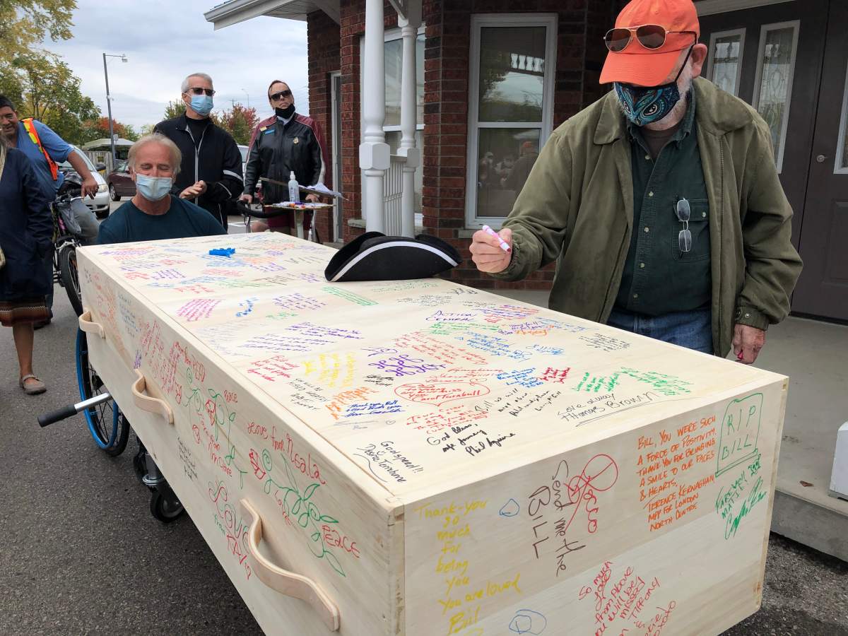 Bill Paul's signature town crier hat lays atop his casket, which is covered with well wishes from those attending his funeral on Friday.