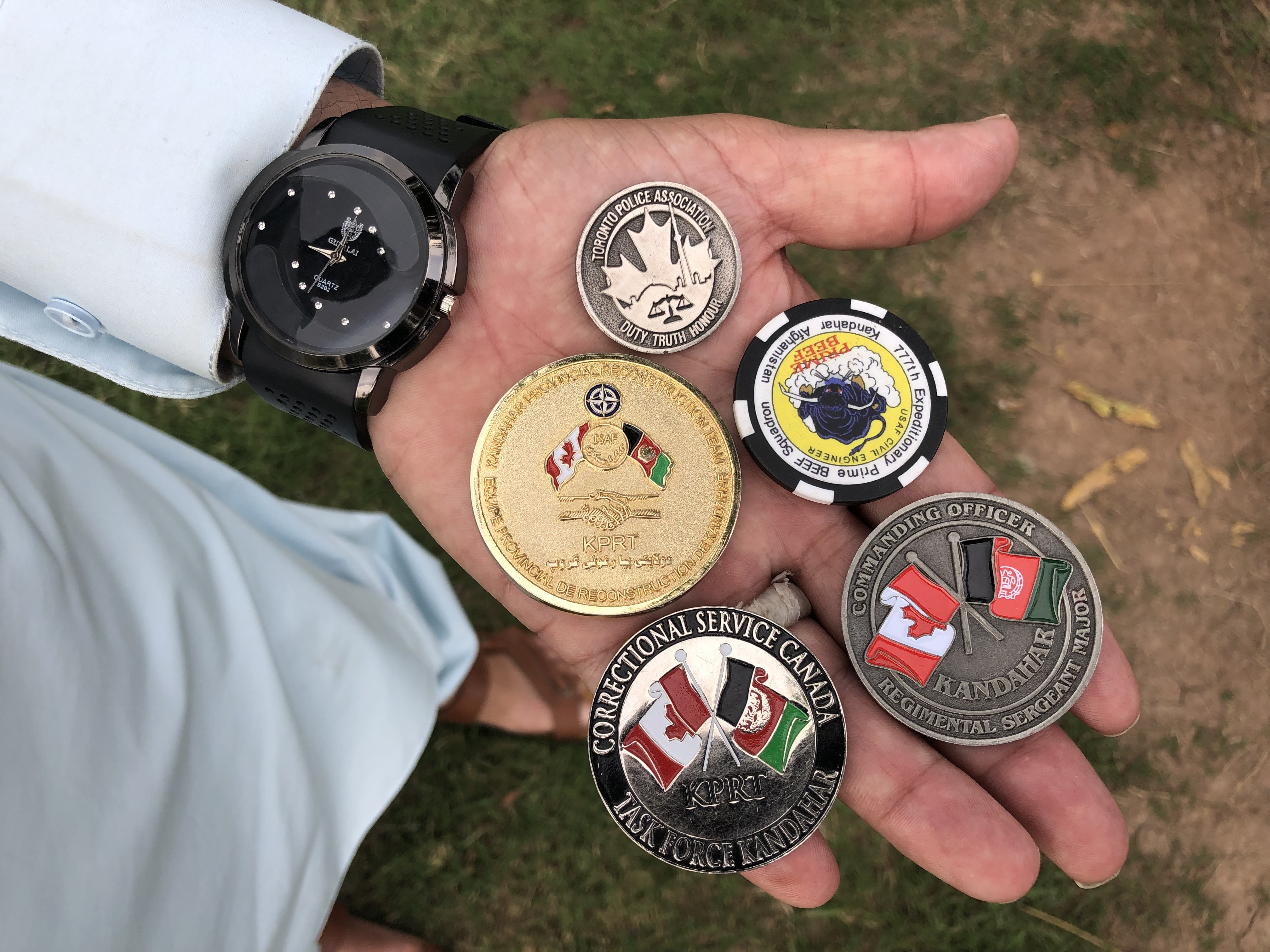 Challenge coins that Canadian agencies gave to Mohammad Ismail when he guarded Camp Nathan Smith in Kandahar.