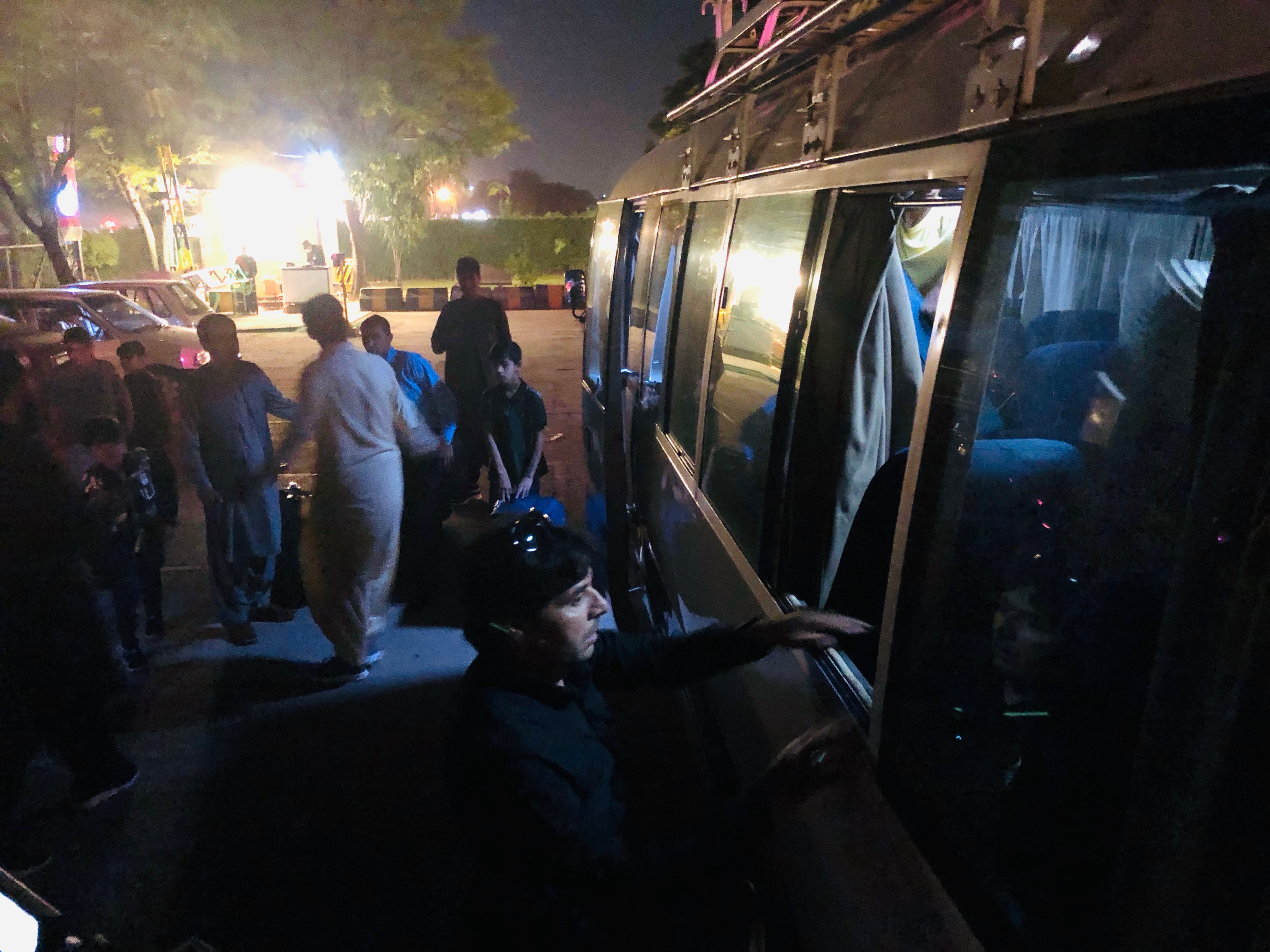 “Captain Smiley” Ismail helps load a bus before leaving for Islamabad airport for the voyage to Canada.