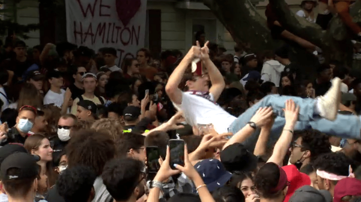 Hundreds of people congregate on a street near McMaster University last year on Oct. 2, 2021.