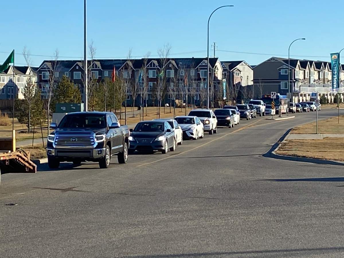 Traffic backed up on Maple Road and 8 Street in southeast Edmonton’s Maple Crest neighbourhood due to a train crossing on Tuesday, Oct. 26, 2021.