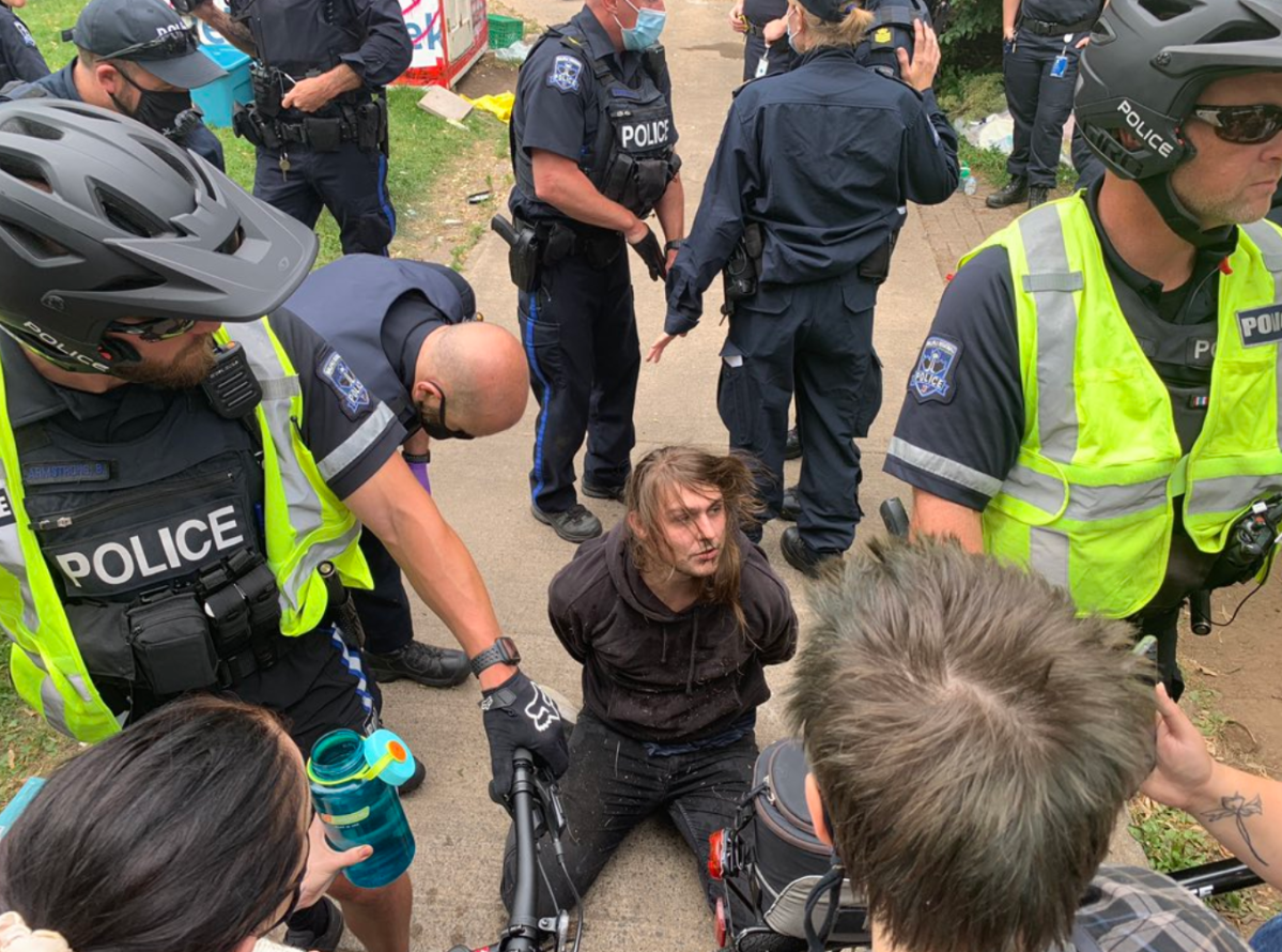 Halifax Regional Police arrest an individual during the homeless shelter removal protest in Halifax on August 18, 2021.