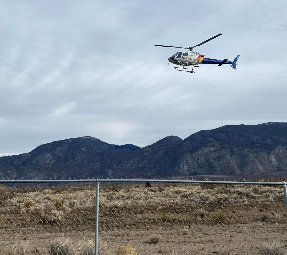An RCMP helicopter lands at Osoyoos airport on Wednesday, Oct. 27, 2021, in connection with a murder-suicide investigation.