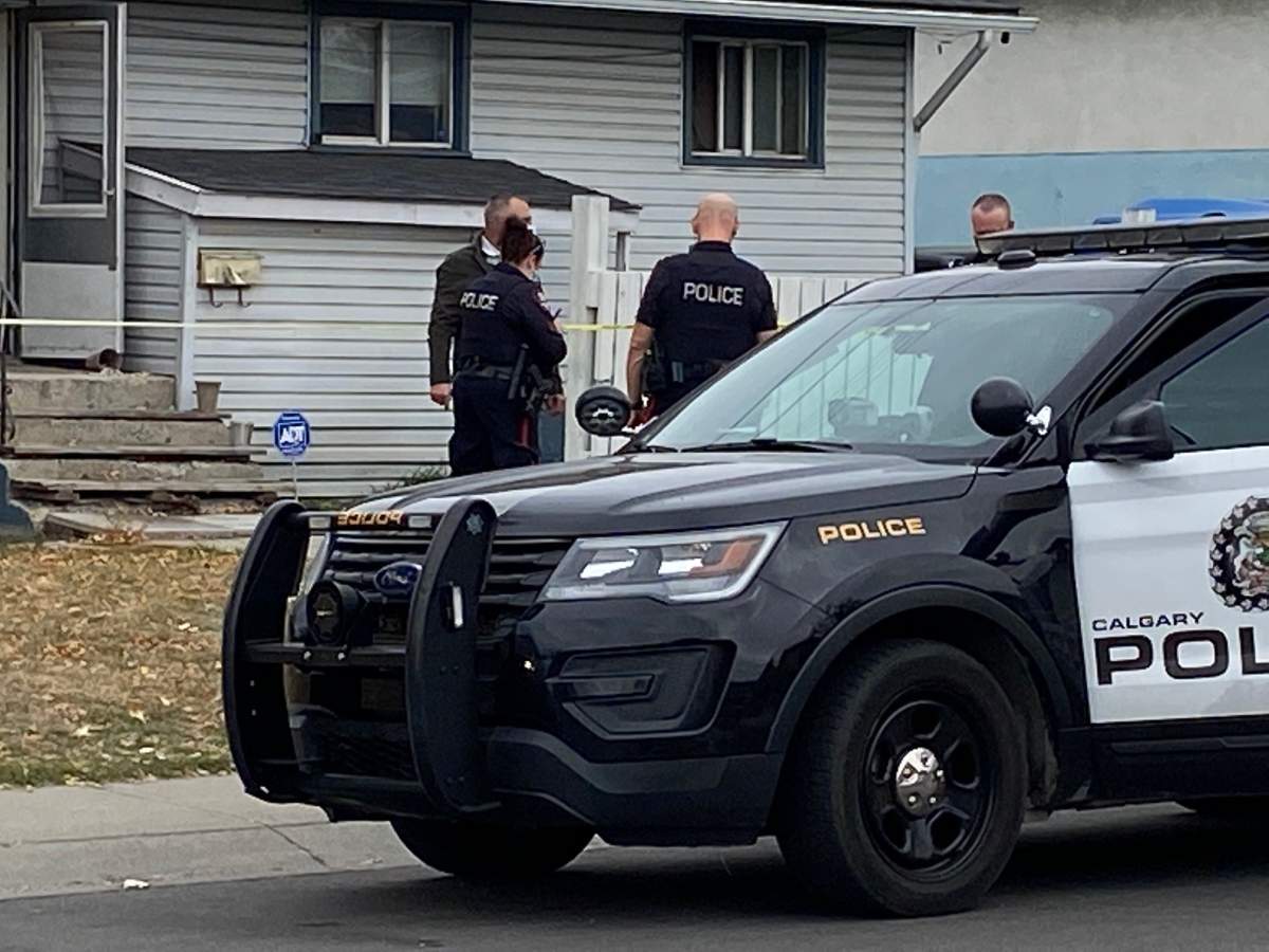 Calgary police officers at a home where an 18-month-old child was found dead on Tuesday, Oct. 5, 2021.