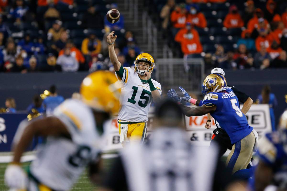 Edmonton Elks quarterback Taylor Cornelius (15) throws against the Winnipeg Blue Bombers during the second half of CFL action in Winnipeg Friday, October 8, 2021. 