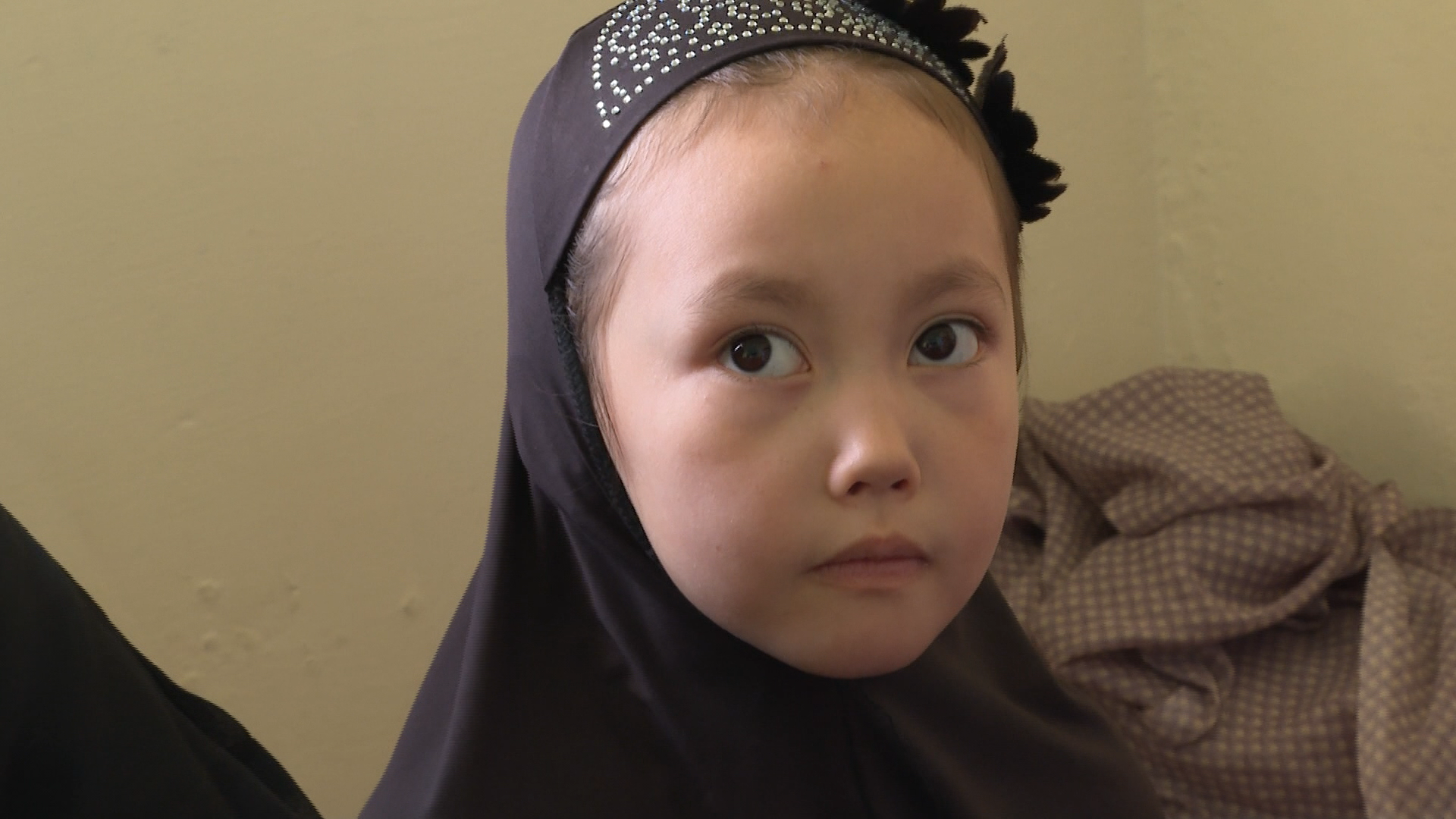 A girl living at an apartment filled with Hazara refugees from Afghanistan.