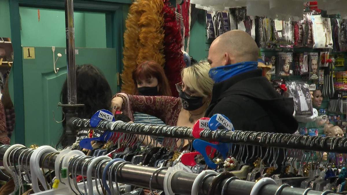 Customers at Calowna Costume being styled in the rentals section for their Halloween costumes.