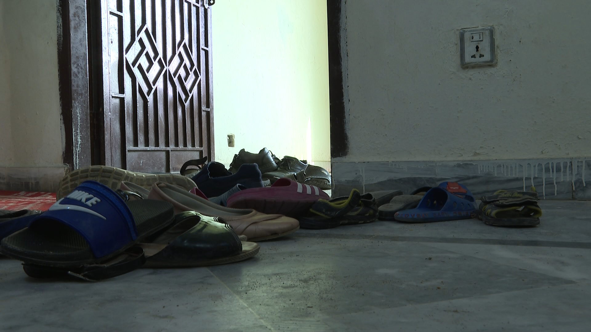 Shoes at the entrance to an Islamabad apartment where Hazara refugees wait to be resettled.