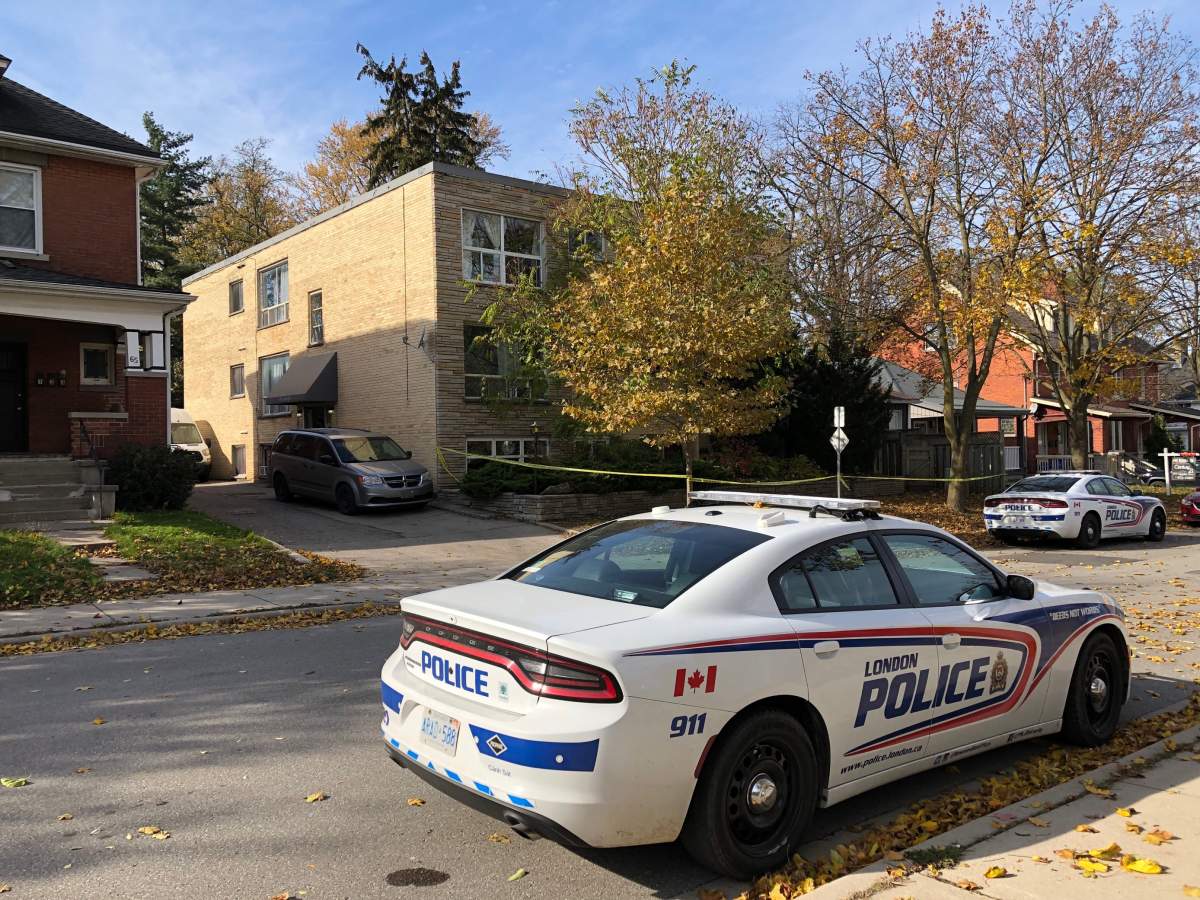 London police vehicles stationed outside of 69 Cartwright St. in London, Ont., for a suspicious death investigation, Nov. 11, 2021.