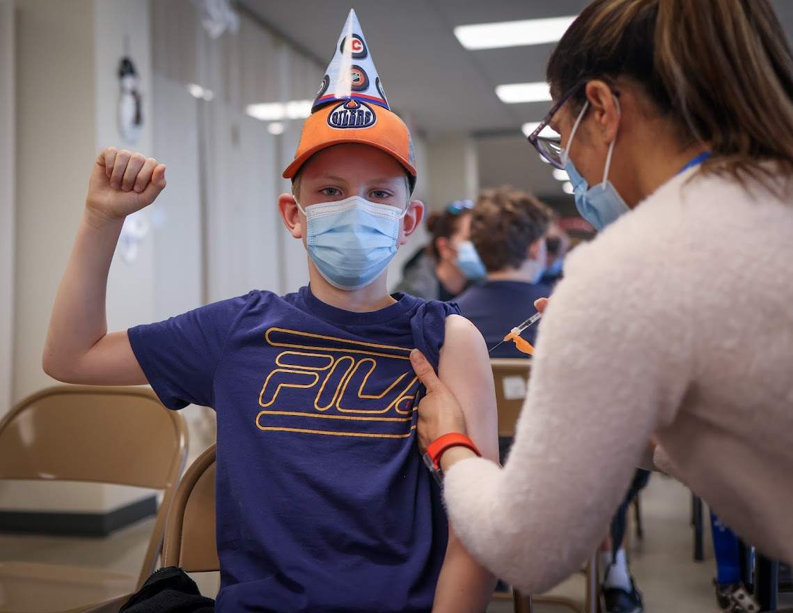 Owen Wilhite, 10, is happy to get a COVID-19 vaccine in Calgary, Alta., on November 26, 2021.