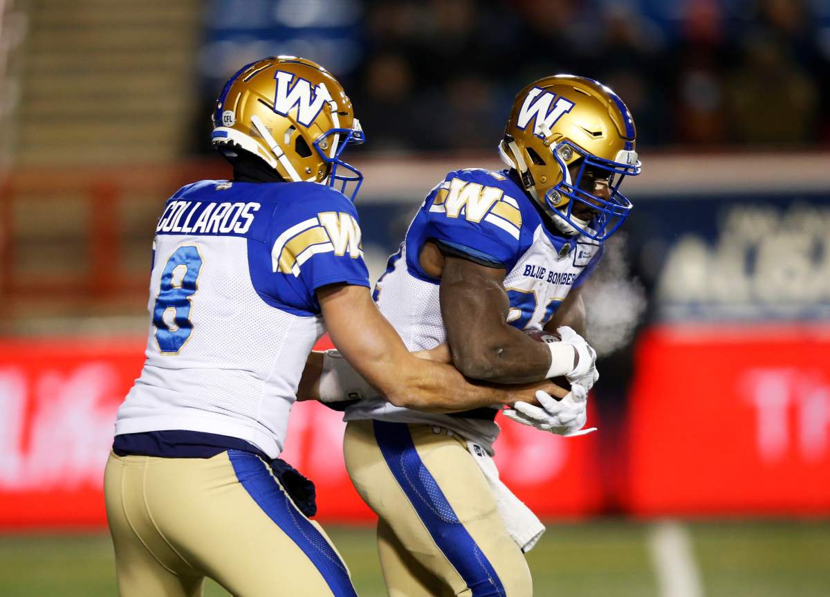 Winnipeg Blue Bombers quarterback Zach Collaros hands the ball off to Johnny Augustine during the first half of their CFL football game against the Calgary Stampeders in Calgary