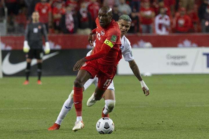 Canada’s captain Atiba Hutchinson (left) gets away from Honduras’ Kervin Arriaga during second half World Cup qualifying action in Toronto on Thursday, September 2, 2021.