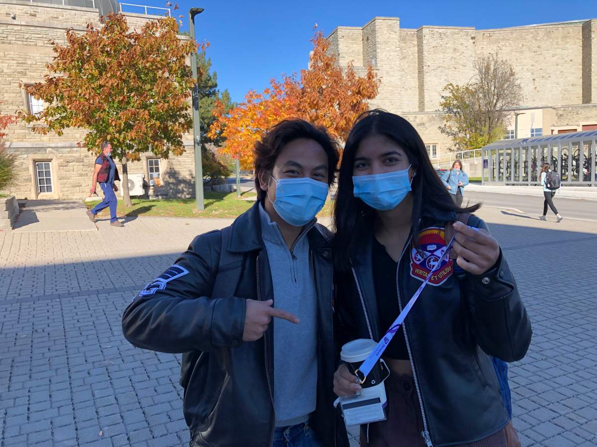 Jericho Salvador (left) and Sushila Chandal pose with the latter’s newly-acquired lanyard and hard plastic ONECard holder.