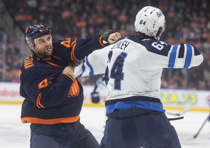 Winnipeg Jets’ Logan Stanley (64) and Edmonton Oilers’ Zack Kassian (44) fight during first period NHL action in Edmonton on Thursday, November 18, 2021.