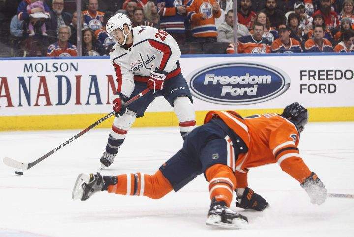 Washington Capitals’ Nic Dowd (26) tries to get around Edmonton Oilers’ Kris Russell (4) during third period NHL action in Edmonton, Alta., on Thursday October 25, 2018.