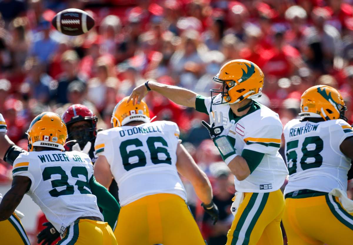 Edmonton Elks quarterback Trevor Harris, centre, throws the ball during first half CFL football action against the Calgary Stampeders in Calgary, Monday, Sept. 6, 2021.