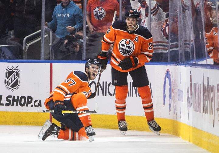 Edmonton Oilers’ Connor McDavid (97) and Leon Draisaitl (29) celebrate a goal against the New York Rangers during third period NHL action in Edmonton on Friday, November 5, 2021.