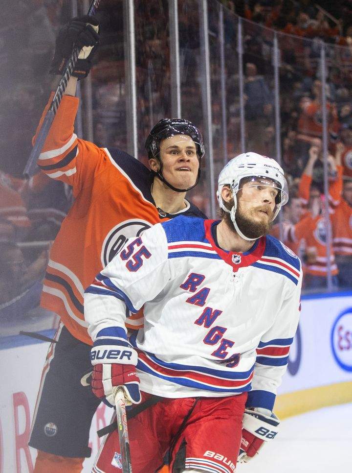 New York Rangers’ Ryan Lindgren (55) looks on as Edmonton Oilers’ Jesse Puljujarvi (13) celebrates a goal during second period NHL action in Edmonton on Friday, November 5, 2021.