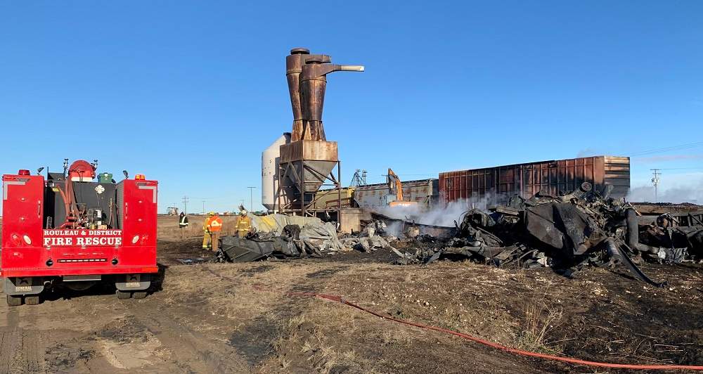 Firefighters are seen at the site of a grain elevator fire on Friday morning in the community of Rouleau, Sask.