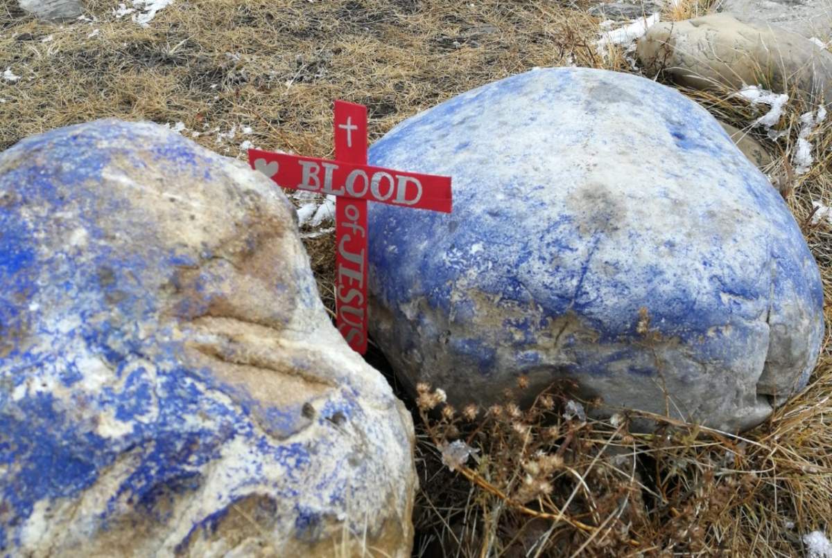 Crosses were placed at the stone marker in Nose Hill Park in Calgary.