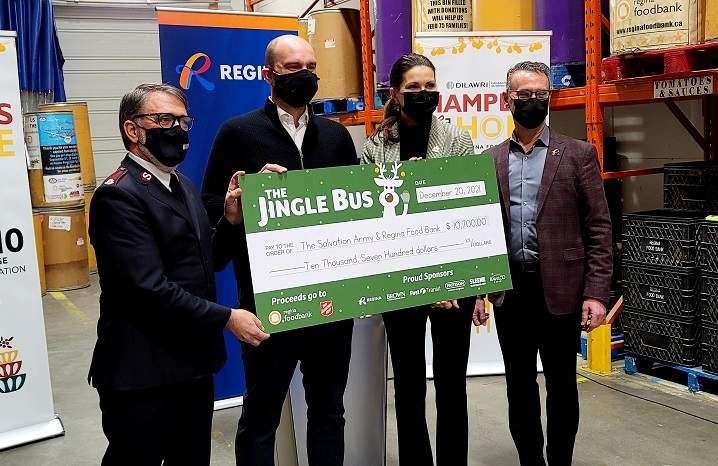 Regina's 2021 Jingle Bus promotion raised $10,700 which will be split between the Salvation Army Haven of Hope and the Regina Food Bank. From left to right: Major Al Hoeft of Salvation Army, John Bailey of Regina Food Bank, Mayor Sandra Masters, executive director of citizen services for the City of Regina Kim Onrait.