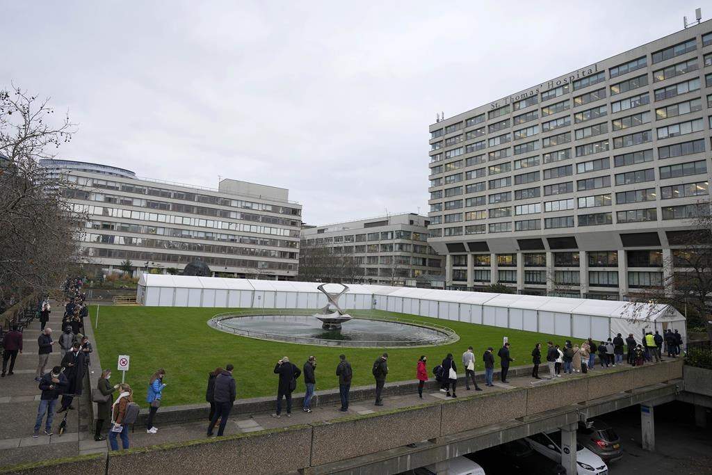 Photo of people lining up for vaccine shots in U.K.