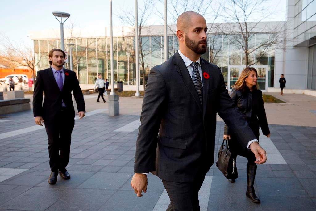 Michael Theriault, centre, and Christian Theriault, left, arrive at the Durham Region Courthouse in Oshawa, Ont. on Wednesday, Nov. 6, 2019. 