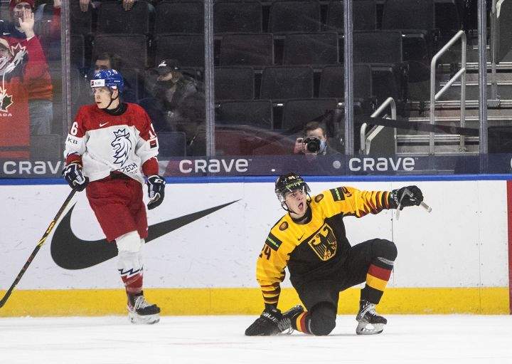 Czech Republic’s Ivan Ivan (16) looks on as Germany’s Alexander Blank (24) celebrates a goal during overtime IIHF World Junior Hockey Championship action in Edmonton on Monday, December 27, 2021.