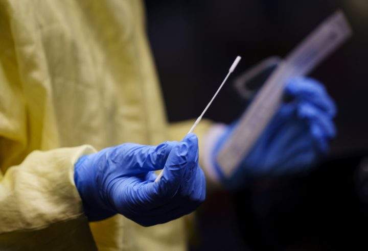 A nurse gets a swab ready to perform a test on a patient at a COVID-19 clinic in this file photo.
