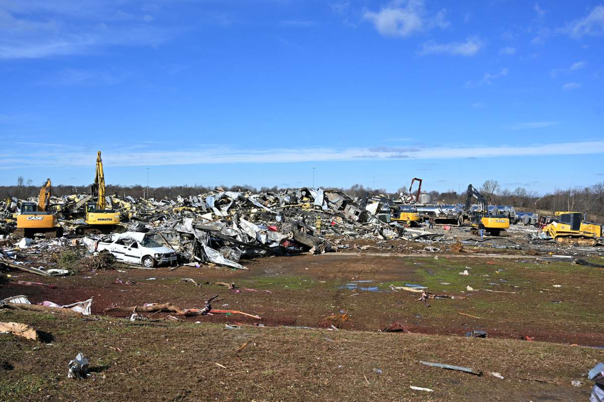 Emergency response workers dig through the rubble of the Mayfield Consumer Products candle factory in Mayfield, Ky., Saturday, Dec. 11, 2021.