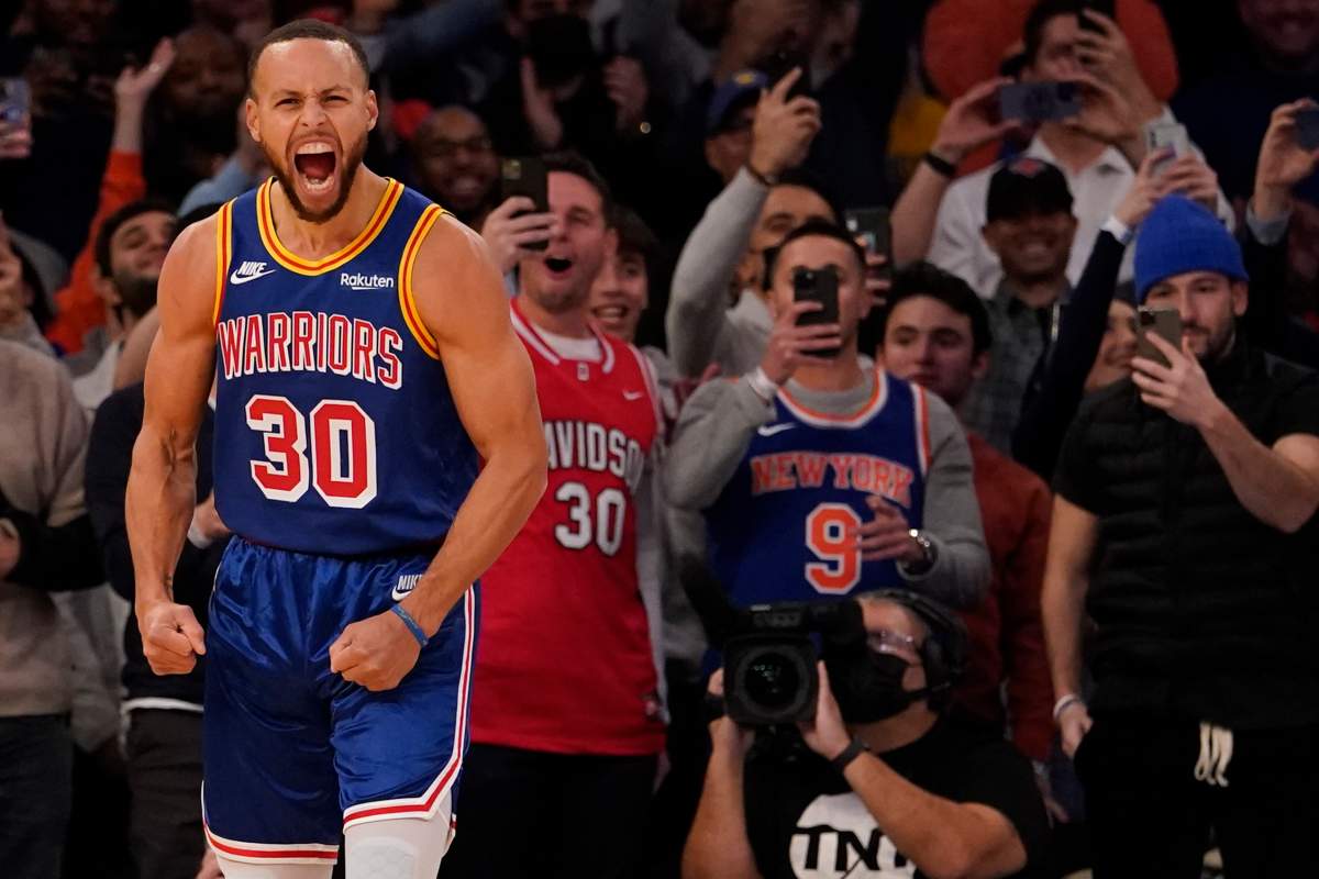 Golden State Warriors guard Stephen Curry reacts after scoring a 3-point basket during the first half of an NBA basketball game against the New York Knicks, Tuesday, Dec. 14, 2021, at Madison Square Garden in New York.