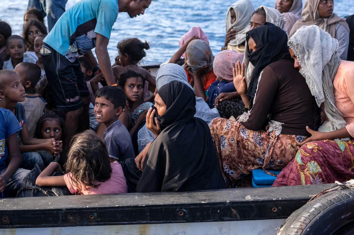 FILE -- Ethnic Rohingya people sit on the deck of a boat off North Aceh, Indonesia, Wednesday, June 24, 2020. Indonesian fishermen discovered dozens of hungry, weak Rohingya Muslims on the wooden boat adrift off Indonesia's northernmost province of Aceh, an official said. (AP Photo/Zik Maulana).
