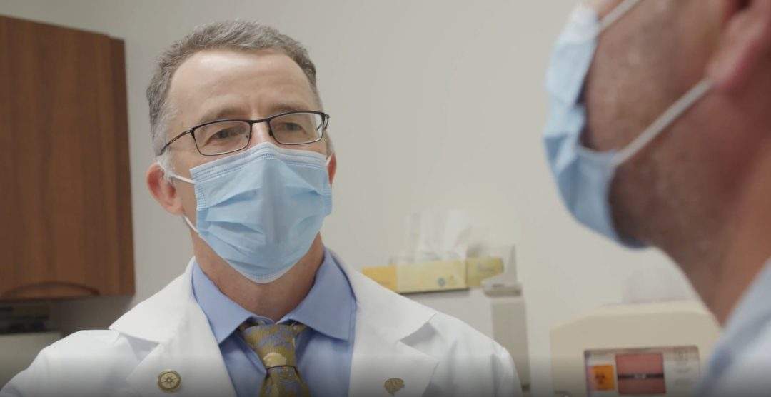 Dr. Igor Koralnik with a patient at the Neuro COVID-19 clinic in Chicago, Illinois.