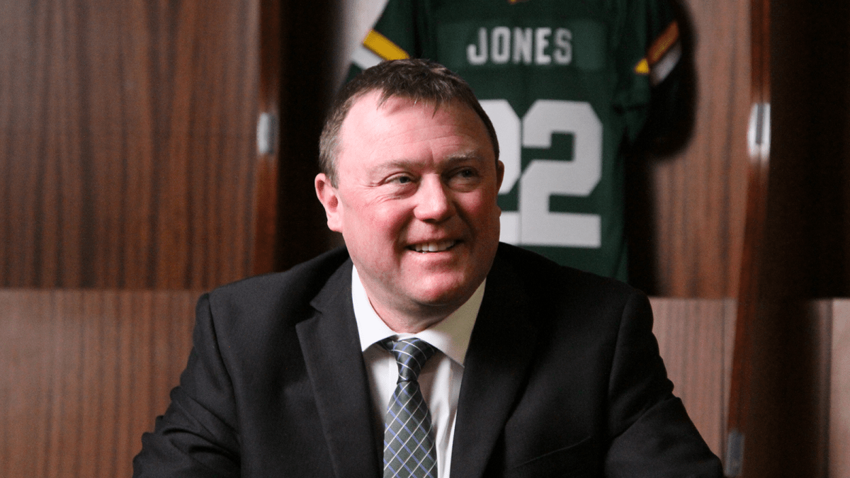 Edmonton Elks head coach and GM Chris Jones smiles during his first day on the job.