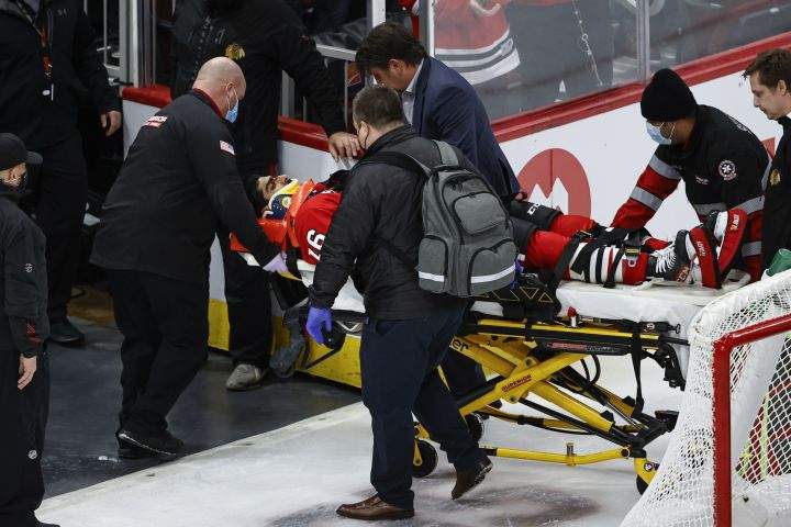 Chicago Blackhawks centre Jujhar Khaira (16) leaves the ice on a stretcher after being knocked out by New York Rangers defenceman Jacob Trouba during the second period of an NHL hockey game, Tuesday, Dec. 7, 2021, in Chicago.