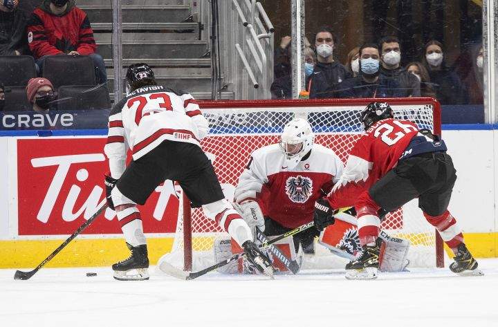 Canada’s Mason McTavish (23) is stopped by Austria’s goalie Leon Sommer (1) as Johannes Tschurnig (26) defends during first period IIHF World Junior Hockey Championship action in Edmonton on Tuesday, December 28, 2021.
