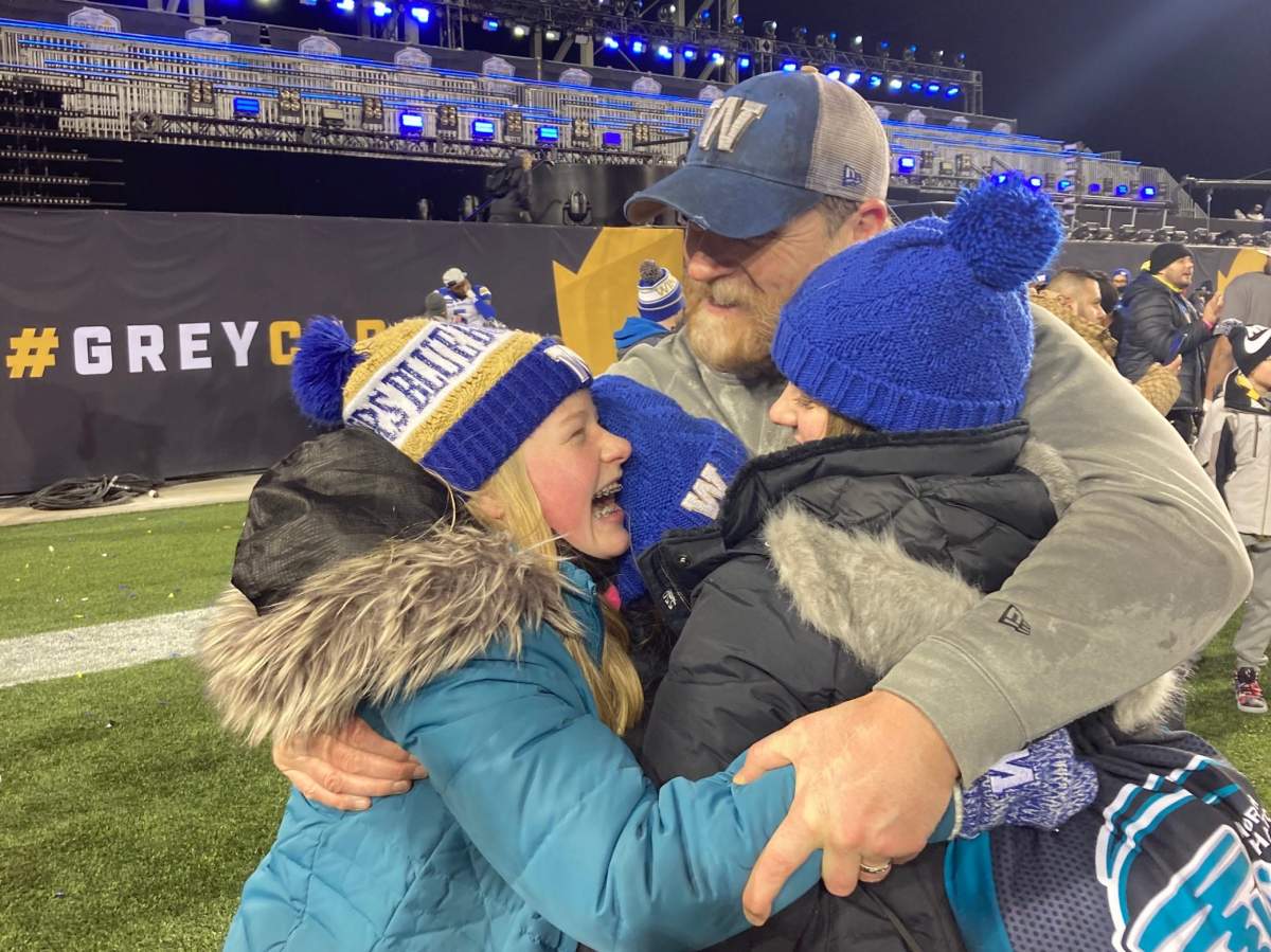 Bombers Head Coach Mike O’Shea gets a celebratory hug from his two daughters on Sunday, Dec. 12, 2021. Skylar Peters/Global News