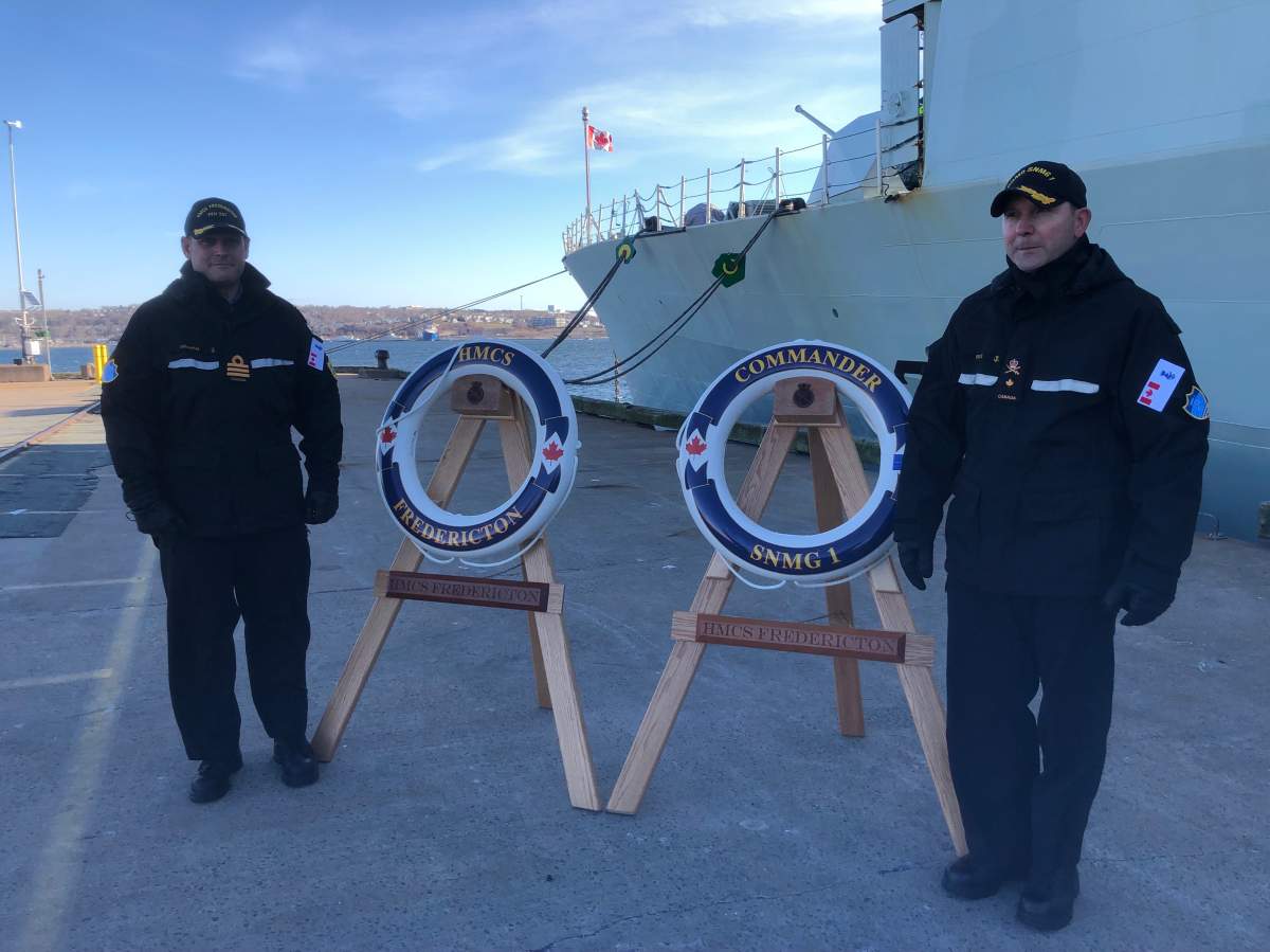 Commander Andrew Graham, commanding officer of HMCS Fredericton, and Commodore Bradley Peats, commander of Standing NATO Maritime Group One.