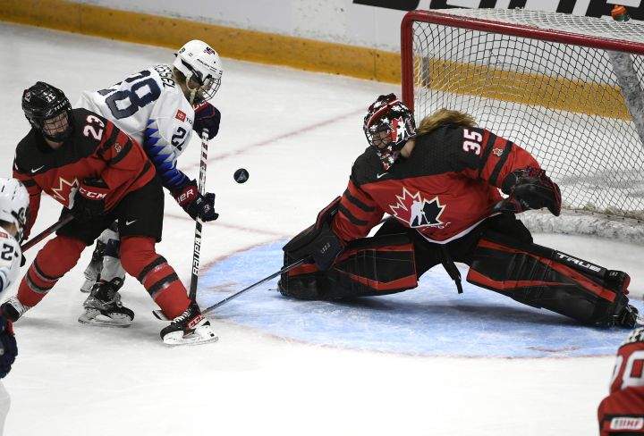 Canada goaltender Ann-Renee Desbiens (35) makes a save in front of teammate Erin Ambrose (23) and United States’ Amanda Kessel (28) during third period Rivalry Series hockey action in Ottawa, on Tuesday, Nov. 23, 2021.