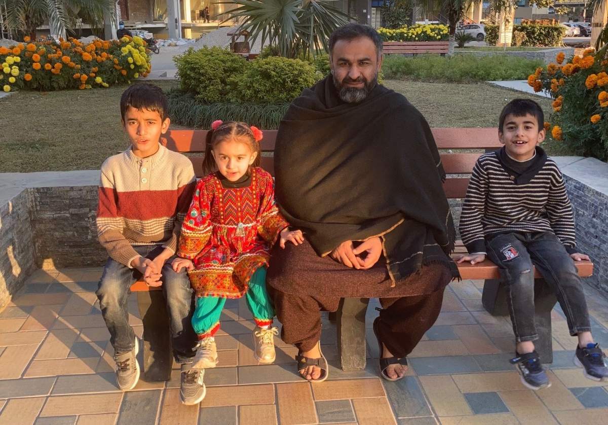 Naveed and his three children in Pakistan in December 2021.