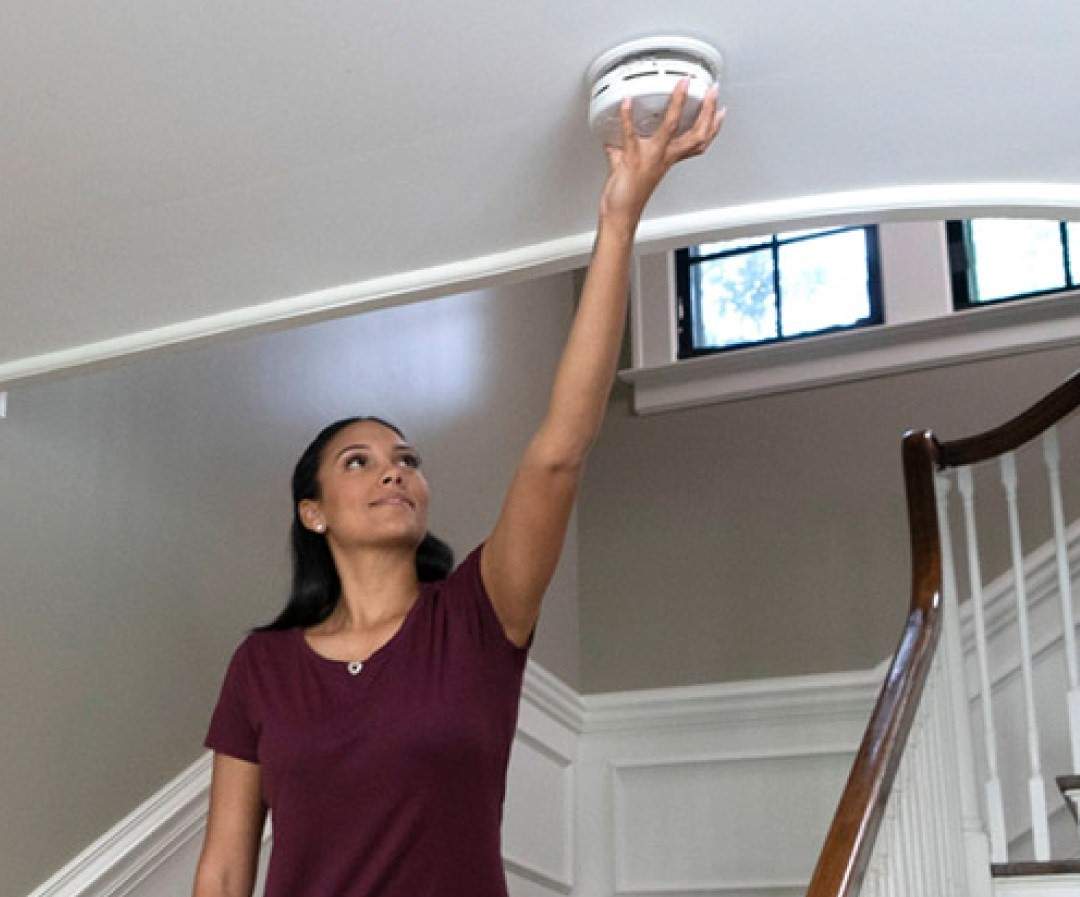 File photo of a person checking a smoke alarm.