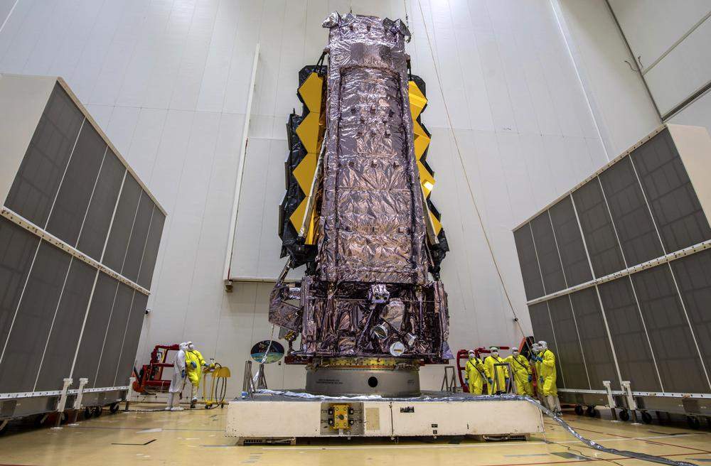 In this Saturday, Dec. 11, 2021 photo released by the European Space Agency, NASA's James Webb Space Telescope is secured on top of the Ariane 5 rocket.