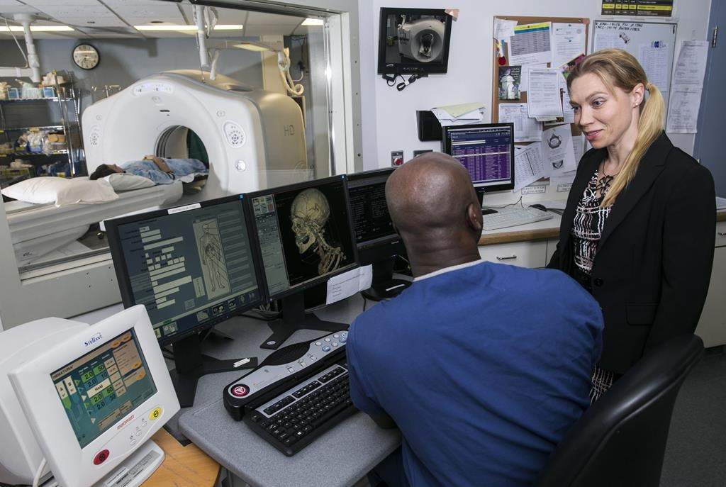 Dr. Ania Kielar, vice-president of the Canadian Association of Radiologists, speaks with a colleague in this undated handout photo.