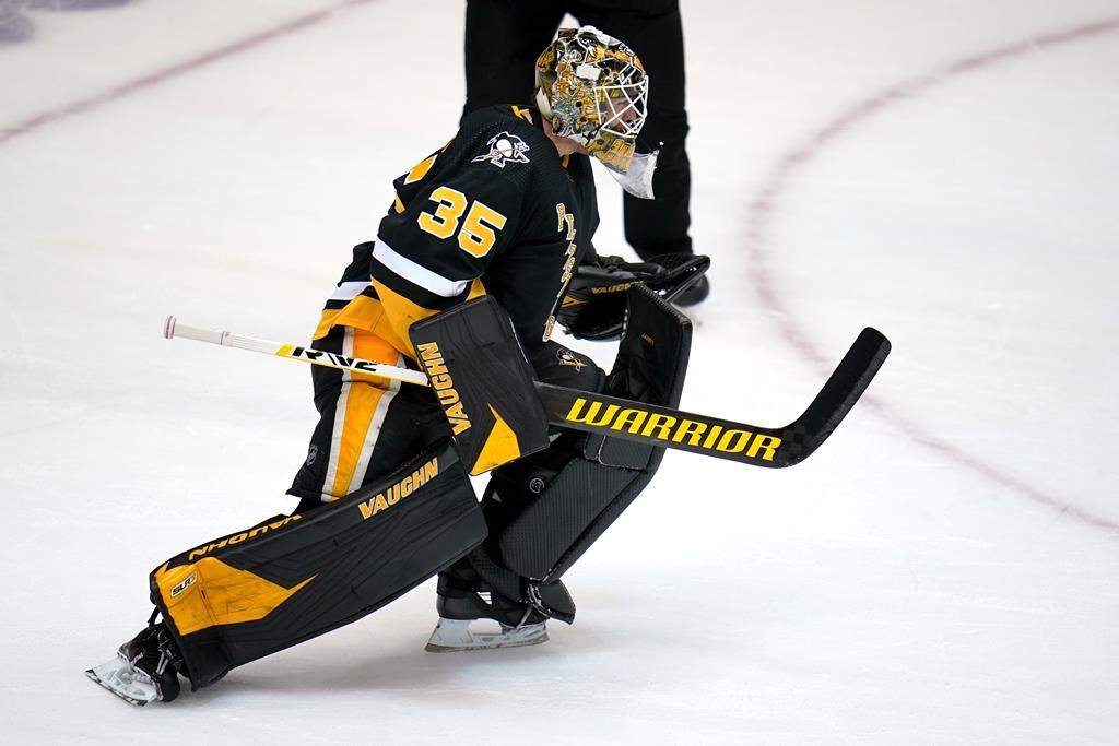 Pittsburgh Penguins goaltender Tristan Jarry begins to celebrate after blocking a shot by Winnipeg Jets' Pierre-Luc Dubois during an NHL hockey game shootout in Pittsburgh, Sunday, Jan. 23, 2022.