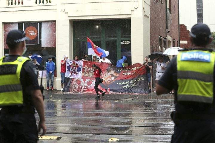 Protestors gather outside an immigration detention hotel where Serbia’s Novak Djokovic is believed to stay, in Melbourne, Australia, Friday, Jan. 7, 2022.