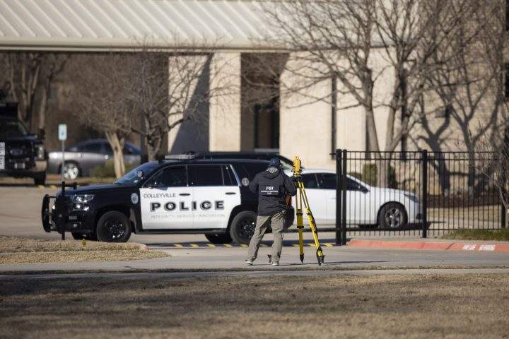 Law enforcement process the scene in front of the Congregation Beth Israel synagogue, Sunday, Jan. 16, 2022, in Colleyville, Texas.