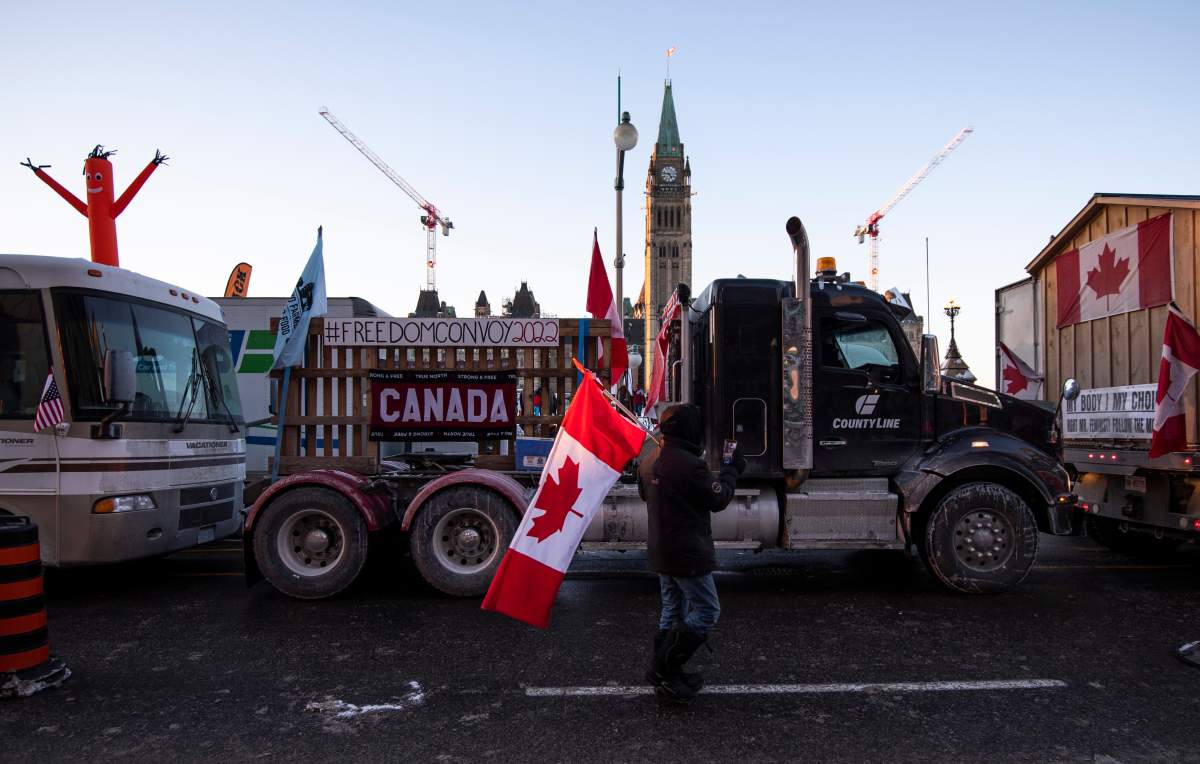 Trucks participating in a cross-country convoy protesting measures taken by authorities to curb the spread of COVID-19 are parked on Wellington Street in front of Parliament Hill in Ottawa, on Friday, Jan. 28, 2022. THE CANADIAN PRESS/Justin Tang