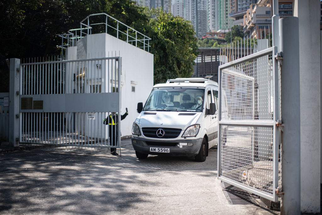 health workers are seen in a van in China wearing full Hazmat gear.